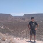 砂漠でポーズをとるメキシコガイドの岩﨑功